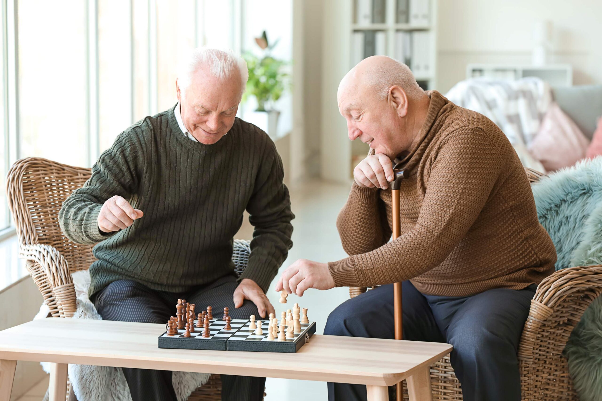 residents-playing-chess Assisted living residents playing games at Orchard Hill in Oakland County